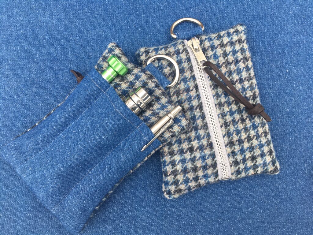 Practical EDC pouch made from traditional tweed fabric on a wooden table